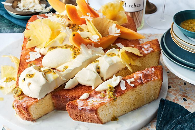 Tropical tres leches cake topped with fresh fruit and cream